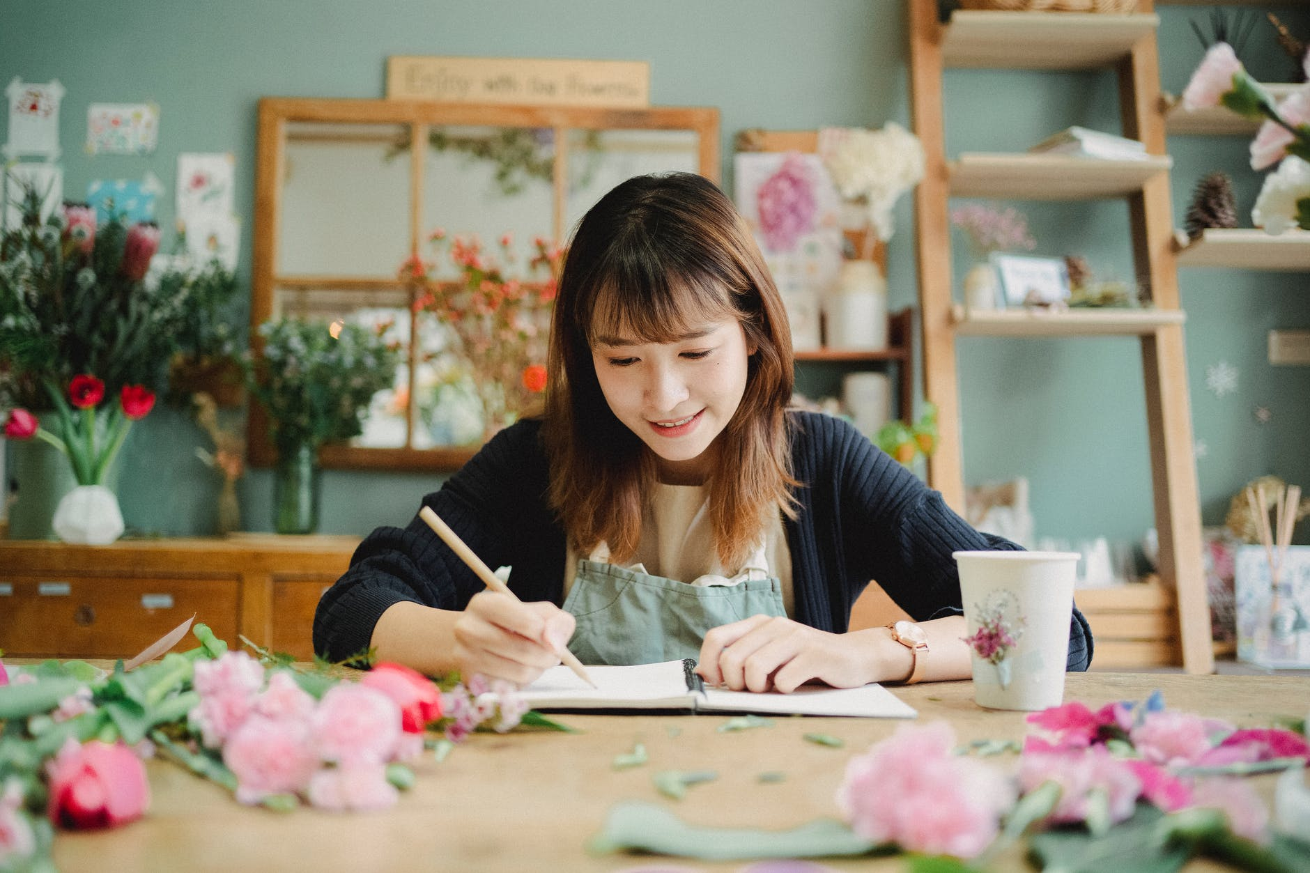 lady sitting at table writing mission statement