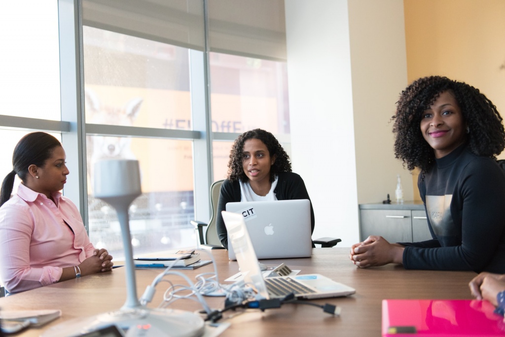 Women having a meeting and operating their computers