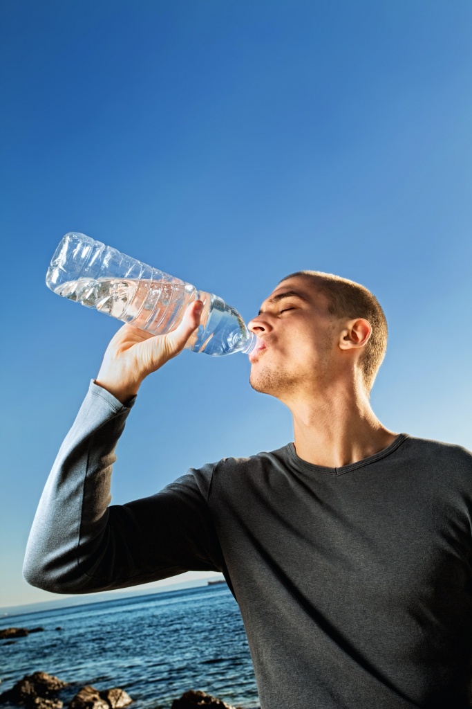 A man drinking water to stay hydrated