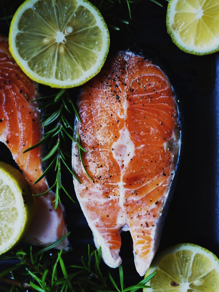 A Salmon fish cooked on pan with vegetables