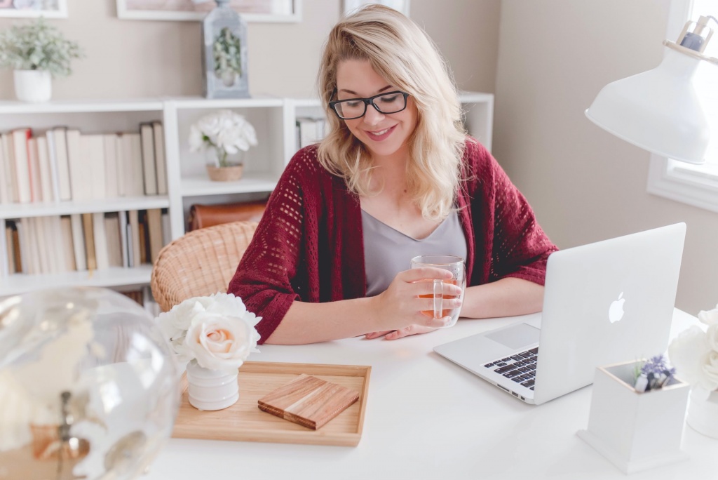 A smiling woman operating a computer