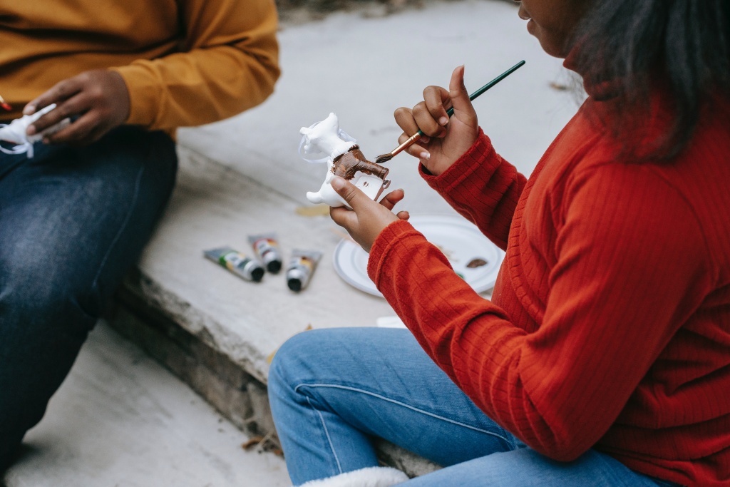 A woman painting a sculpture