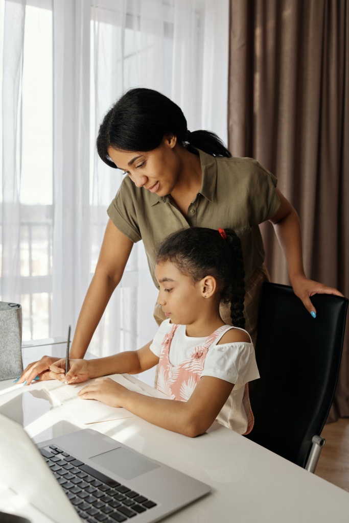 A mother teaching her daughter from home. Homeschool