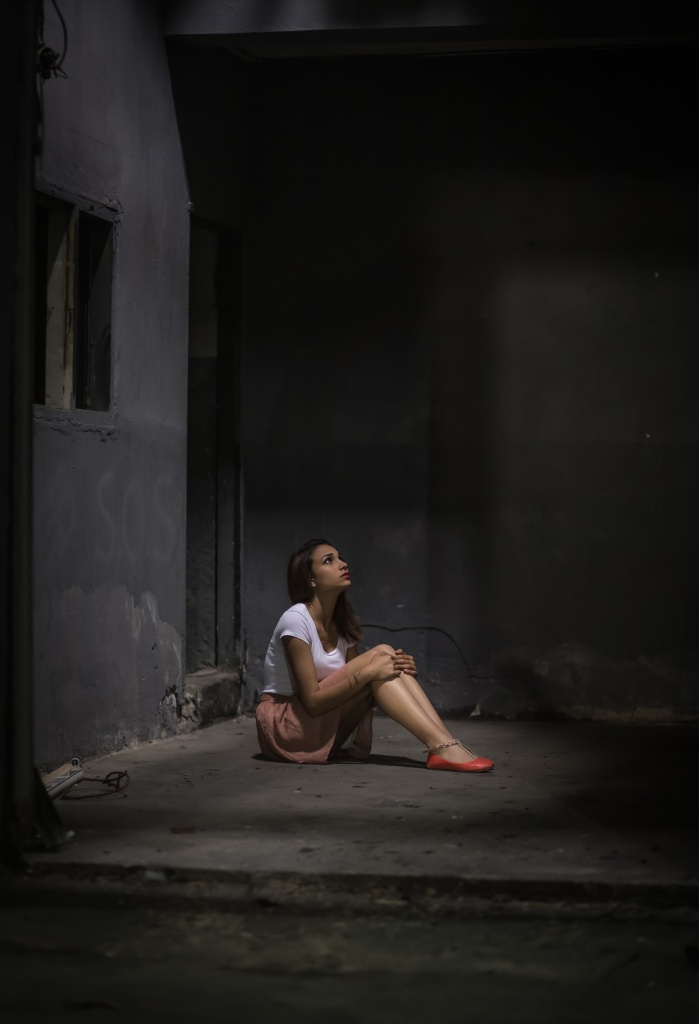 a lady thinking and sitting on the floor