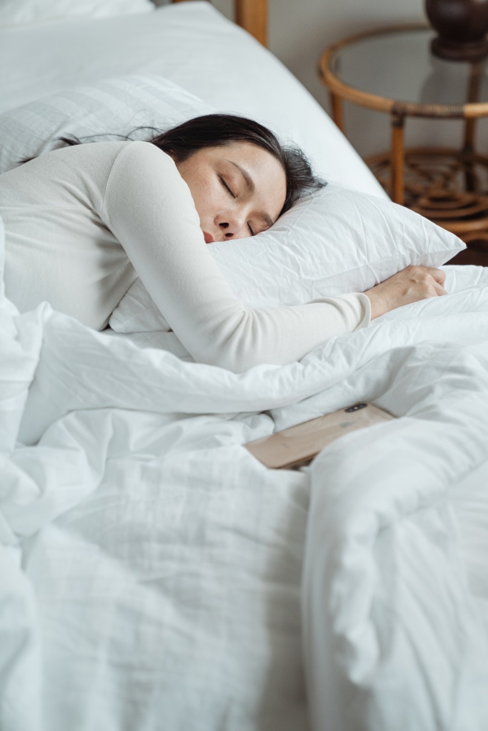 A woman sleeping to help relieve stress