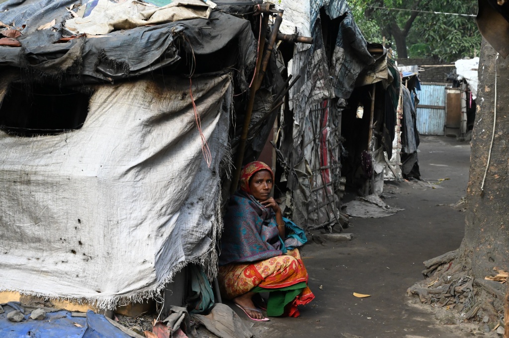 A woman sitting in a refugee camp