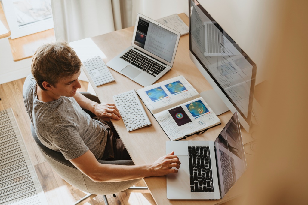 A man operating multiple computers