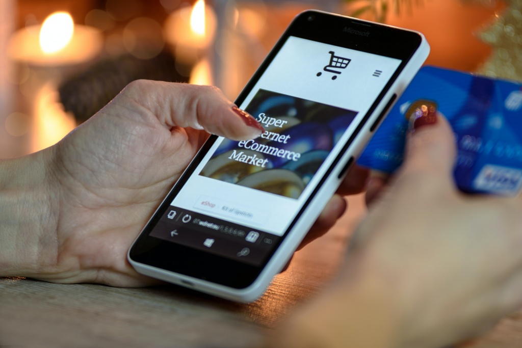 A woman buying items on an online store with a phone