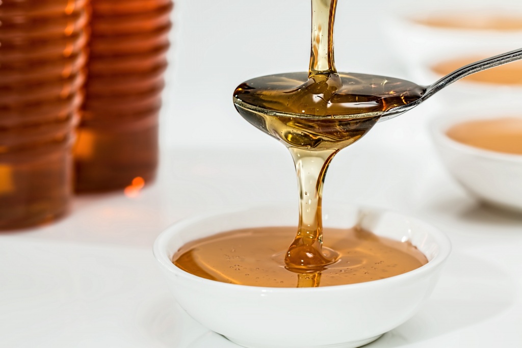 pouring honey in a bowl