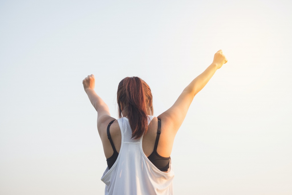 A lady raising her hands up