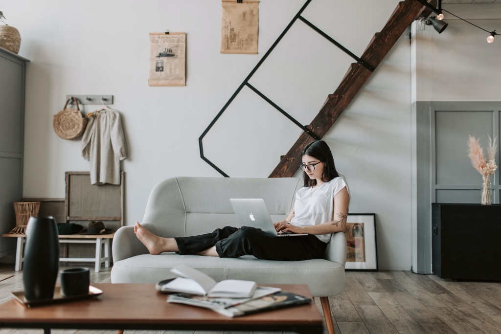 A woman sitting on a chair and working on her computer