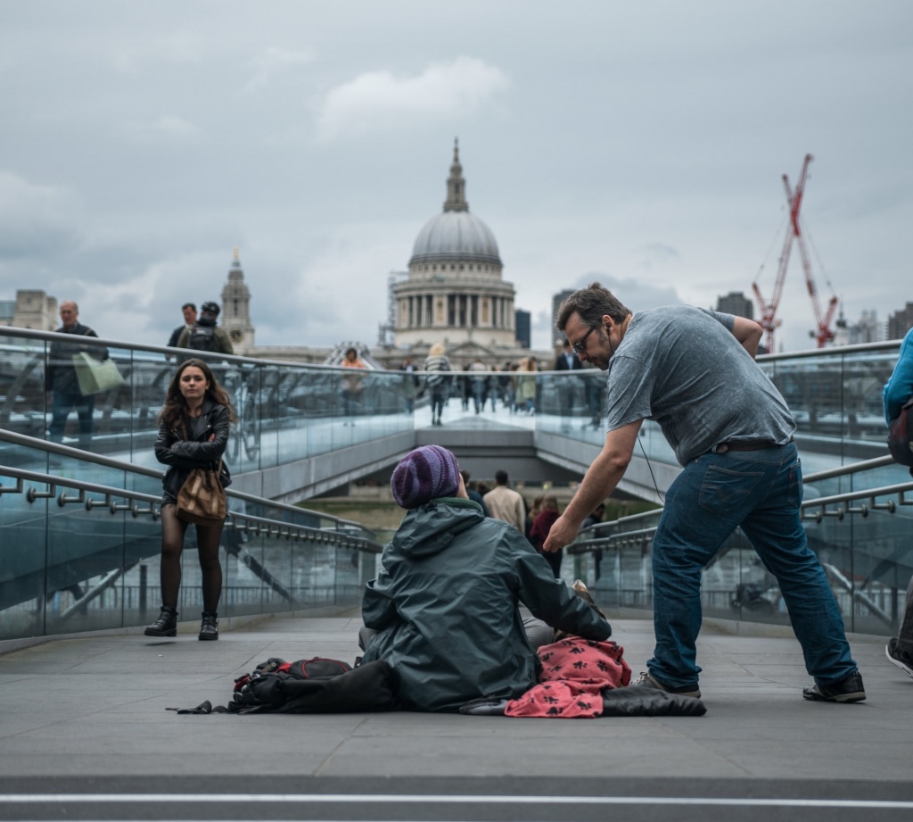 A man giving money to a woman on the streets